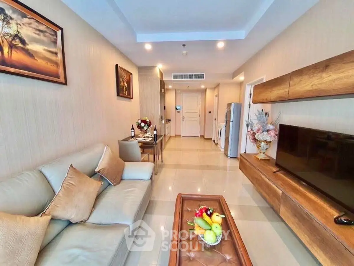 Modern living room with elegant decor, cozy seating, and sleek entertainment unit.