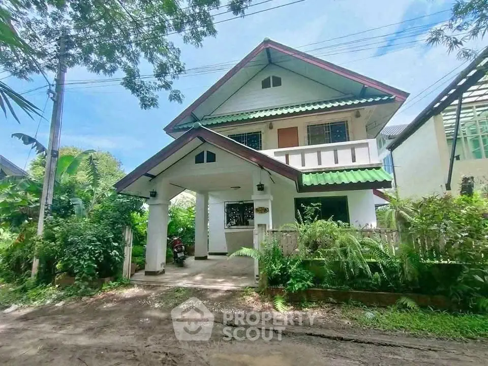 Charming two-story house with lush greenery and inviting entrance in a serene neighborhood.