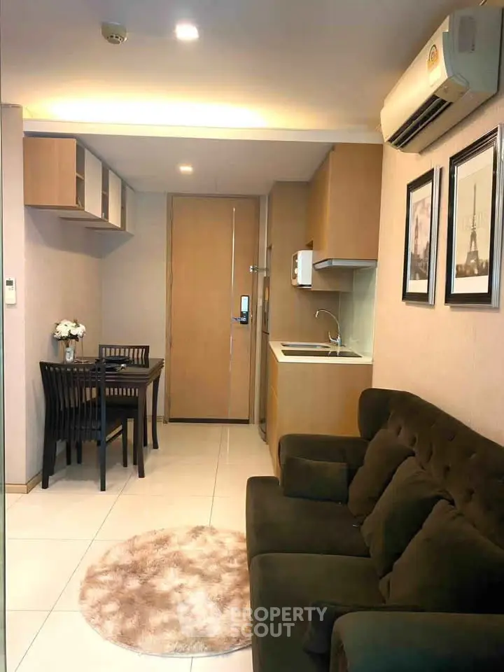 Cozy modern living room with compact kitchen and dining area, perfect for urban living.