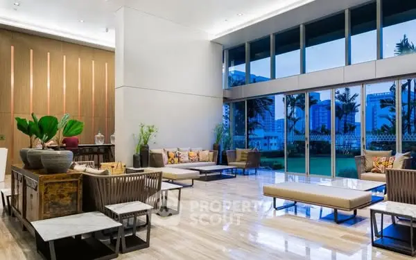 Luxurious modern living room with floor-to-ceiling windows and elegant decor.