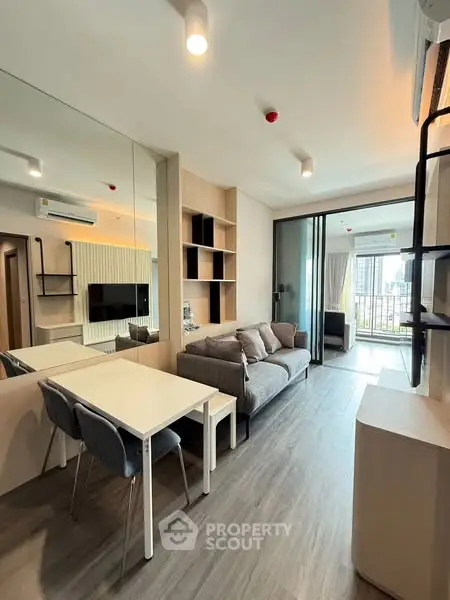 Modern living room with sleek design and city view balcony, perfect for urban living.