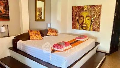 Luxurious bedroom with elegant decor and serene Buddha artwork