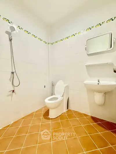 Spacious bathroom with modern fixtures and tiled flooring in a real estate property.
