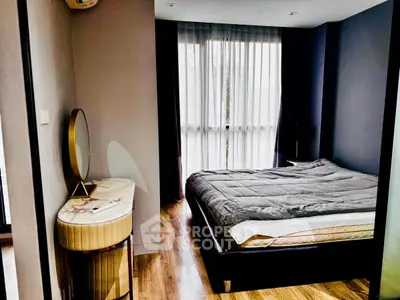 Modern bedroom with stylish decor and large window for natural light.