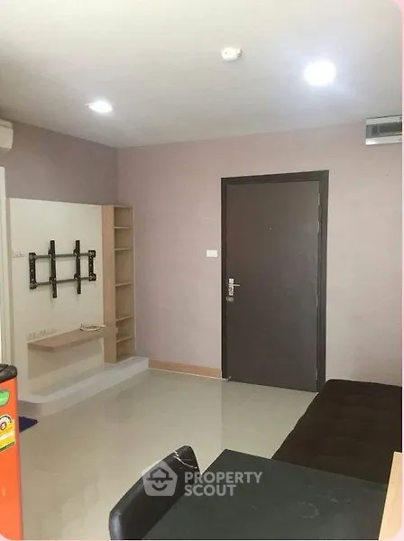 Modern apartment interior with wall-mounted TV setup and sleek furniture