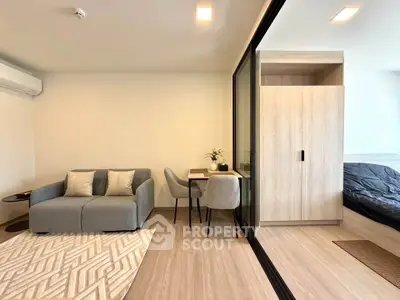 Modern living room with cozy sofa and dining area in open-plan apartment
