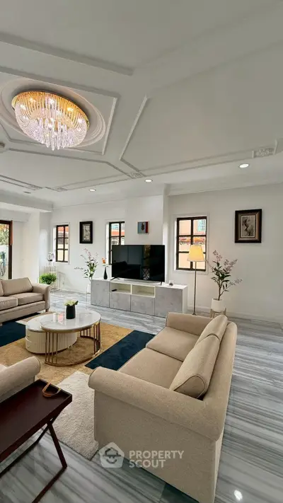 Luxurious living room with elegant chandelier and modern decor