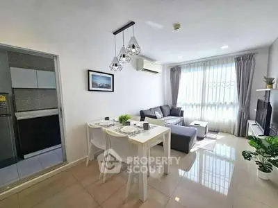 Modern living room with dining area, stylish decor, and natural light in a contemporary apartment.