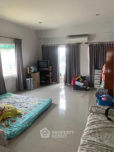 Spacious bedroom with natural light and modern decor