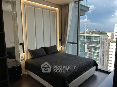 Luxurious bedroom with floor-to-ceiling windows offering stunning city views in a modern high-rise apartment.