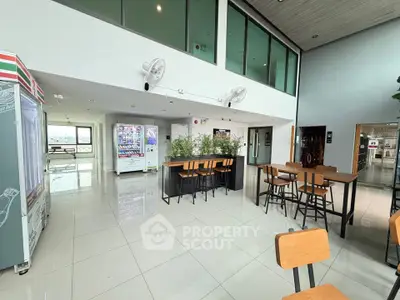 Modern communal area with vending machines and seating, ideal for relaxation and socializing.