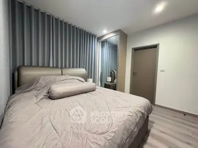Modern bedroom with stylish decor and cozy bedding in a contemporary apartment.