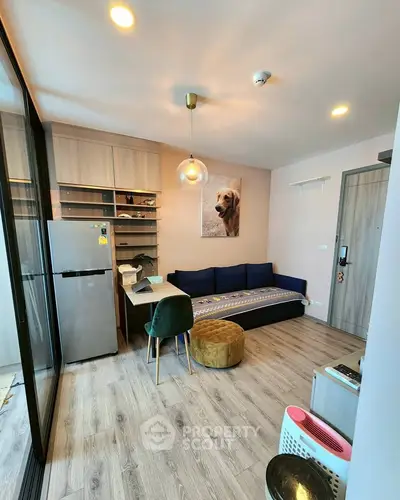 Modern living room with stylish decor and open layout, featuring a cozy seating area and contemporary lighting.