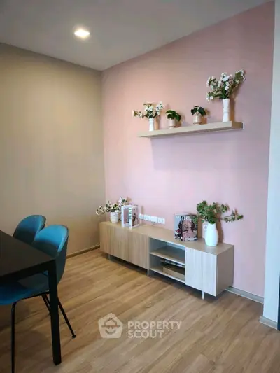 Stylish modern living room with pink accent wall and elegant decor.