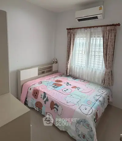 Cozy bedroom with air conditioning and charming cartoon-themed bedding, perfect for a child's room.