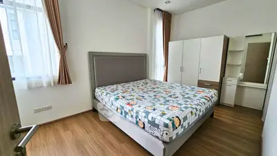 Spacious bedroom with modern furniture and natural light