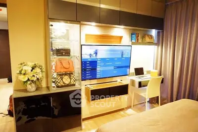 Modern living room with stylish TV setup and cozy workspace