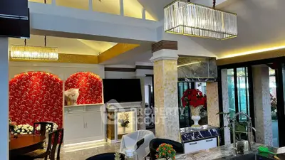 Luxurious open-plan living area with elegant decor and modern lighting fixtures.