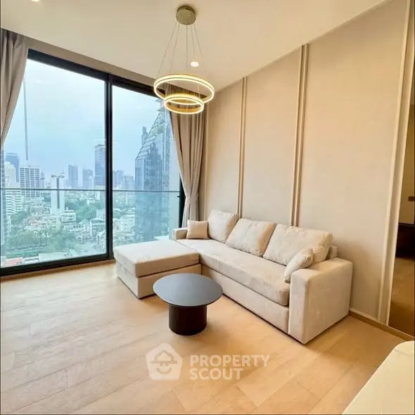 Modern living room with city view, elegant lighting, and cozy seating area.