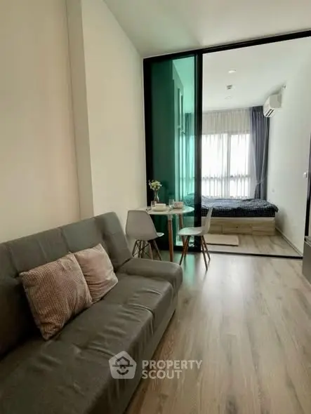 Modern studio apartment with open living area and cozy bedroom