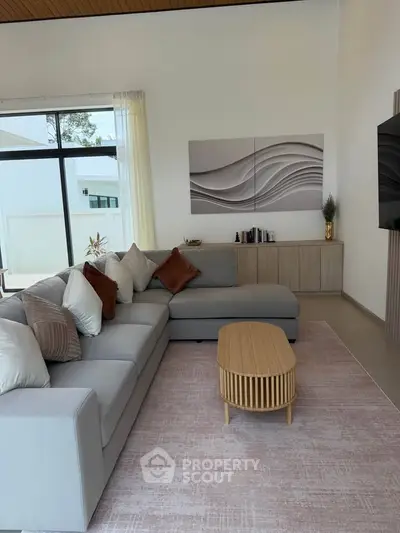 Spacious modern living room with elegant decor and large windows