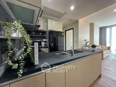 Modern open-layout kitchen with sleek countertops and integrated appliances in a stylish apartment.