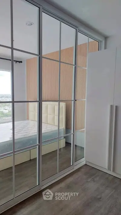 Modern bedroom with mirrored wardrobe and stylish decor