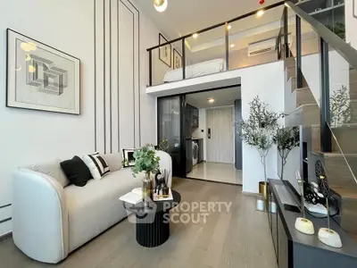 Modern loft apartment with stylish living room and mezzanine bedroom, featuring chic decor and open layout.
