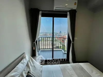 Modern bedroom with balcony offering stunning city view, featuring sleek design and air conditioning.