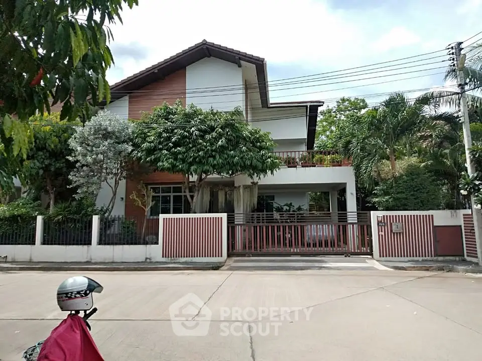 Charming suburban house with lush greenery and modern design, perfect for family living.