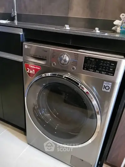 Modern kitchen with sleek washing machine and stylish cabinetry