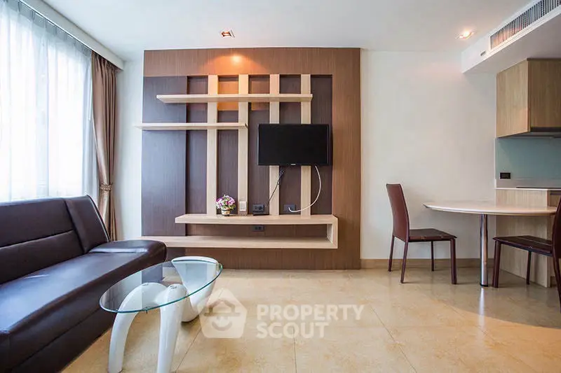 Modern living room with stylish wall panel and sleek furniture