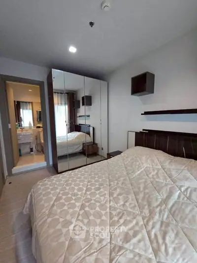 Cozy bedroom with mirrored wardrobe and elegant decor