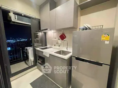 Modern kitchen with sleek appliances and city view balcony