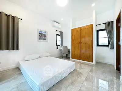 Spacious minimalist bedroom with large windows and modern decor