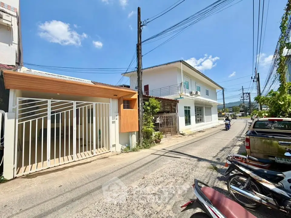 Charming suburban street view with modern homes and clear blue skies, perfect for tranquil living.