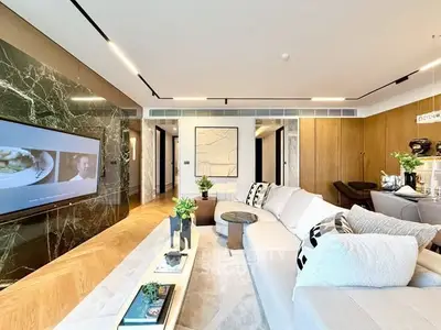 Luxurious modern living room with elegant decor and large TV, perfect for relaxation and entertainment.