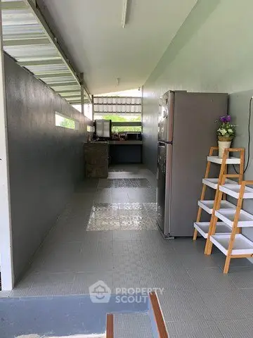 Spacious kitchen with modern appliances and open layout, perfect for culinary enthusiasts.