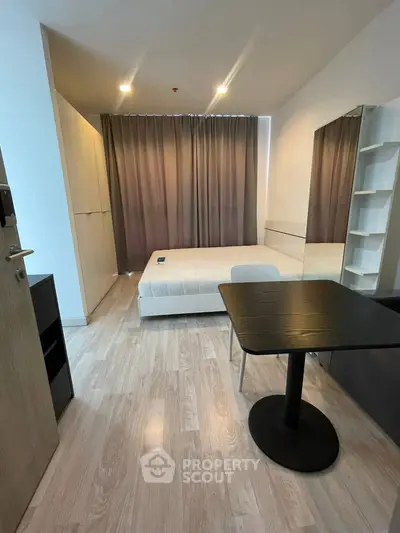 Modern minimalist bedroom with sleek furniture and large mirror