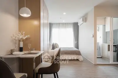 Modern studio apartment with open layout, featuring cozy dining area and stylish bedroom.