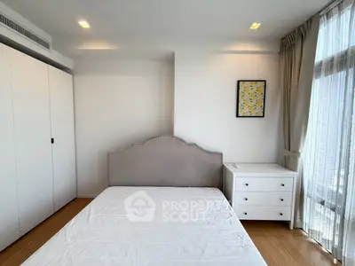 Bright and modern bedroom with large window and stylish decor