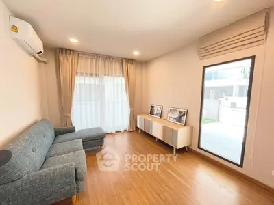 Modern living room with stylish furniture and large window for natural light.
