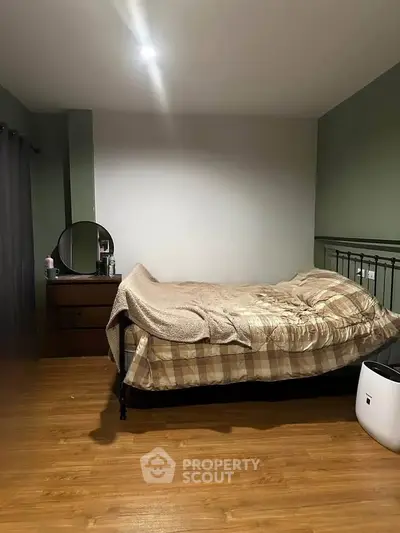 Cozy bedroom with wooden flooring and stylish decor