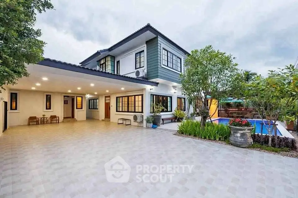 Stunning modern two-story home with spacious driveway and inviting pool area.