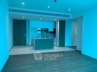 Modern open-layout kitchen with sleek cabinetry and island in a spacious apartment.