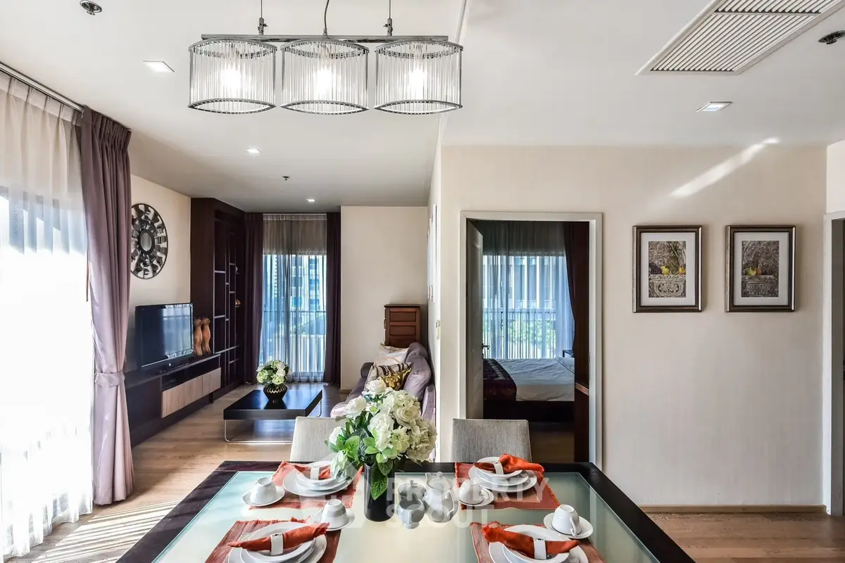 Elegant open-plan living and dining area with modern decor and natural light.