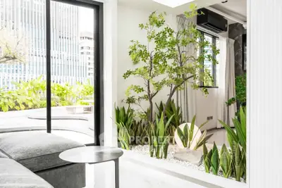 Modern living room with indoor garden and large windows offering city view