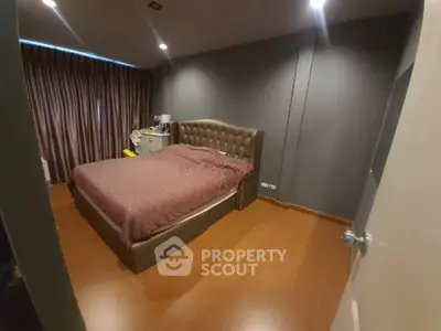 Spacious and elegantly designed bedroom with a large comfortable bed, plush headboard, and warm ambient lighting, perfect for relaxation.