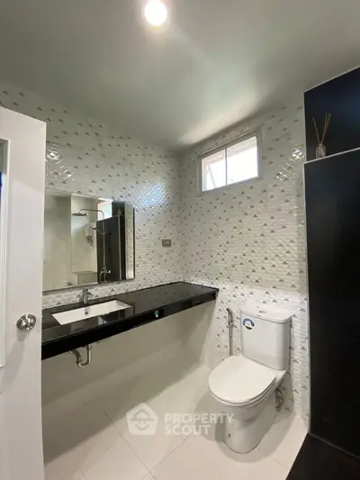 Modern bathroom with sleek black countertop and stylish tile design
