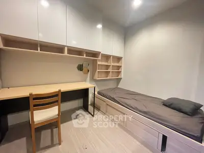 Modern minimalist bedroom with built-in storage and study desk